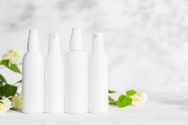 Merkloze huidverzorgingsproducten plastic fles met dispenser en flacons