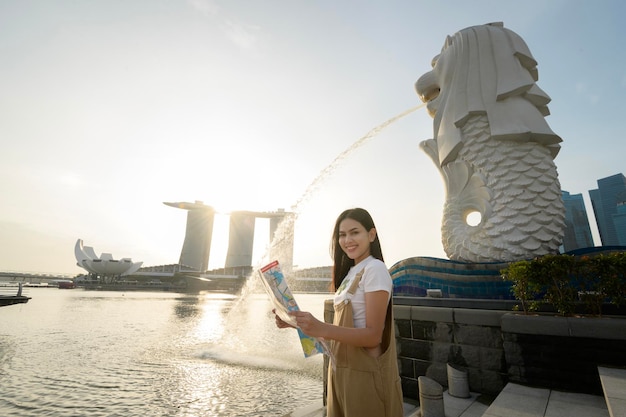 Merlion fontein voor de Marina Bay met jonge Aziatische vrouwelijke toerist