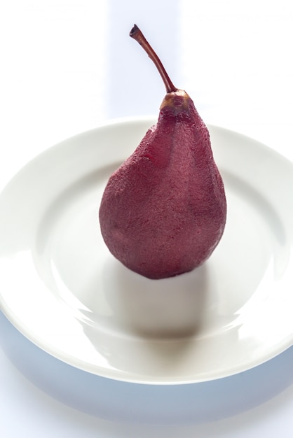 Merlot-poached pear on the plate