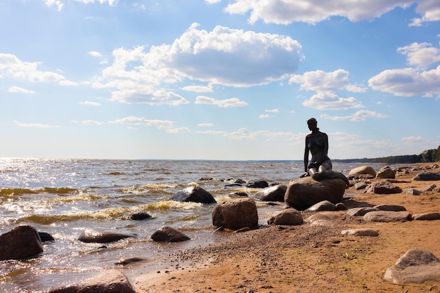 Mermaid statue on seashore on sunny day St Petersburg Russia June 2021