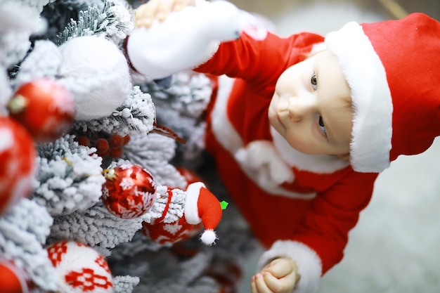 Merry bright christmas. Lovely baby enjoy christmas. Childhood memories. Santa girl little child celebrate christmas at home. Family holiday. Girl cute child cheerful mood play near christmas tree.