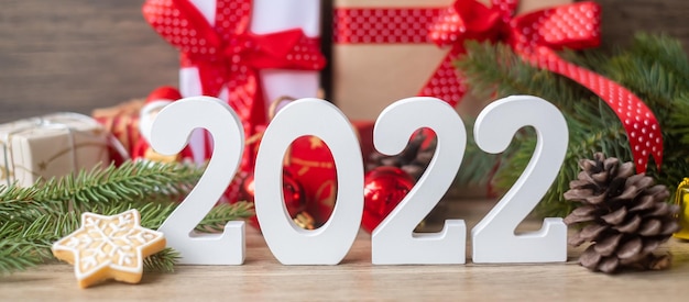 Merry Christmas and 2022 Happy New Year with decoration on table. Xmas eve, party, holiday and boxing day concept