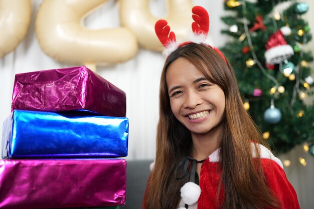 Photo merry christmas 2024 concept asian women are happy and delighted to receive christmas gifts