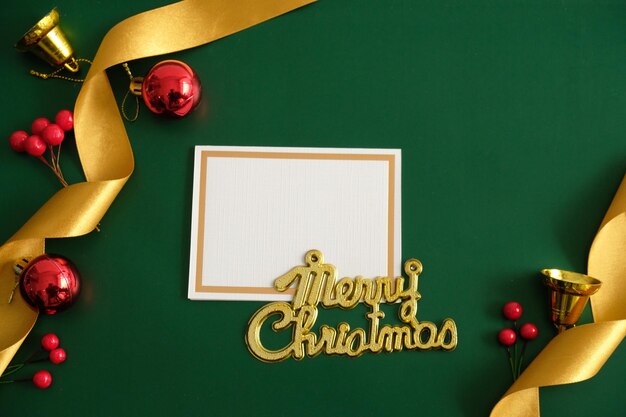 Photo merry christmas background for holiday greetings card with bell ribbon ornament