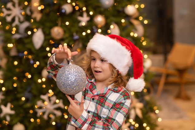 Merry christmas christmas and happy holidays at home cheerful cute kid boy decorated christmas tree