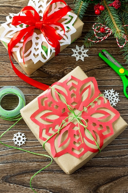 Merry Christmas concept Packing presents for Christmas in handmade boxes on wooden table