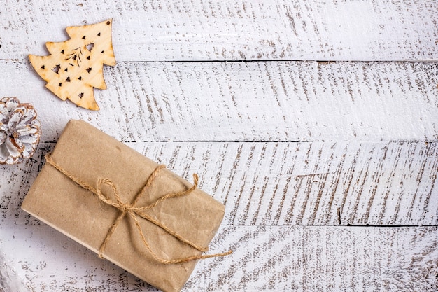 Merry christmas concepts with gift box and ornament element on white wooden table background with copy space.