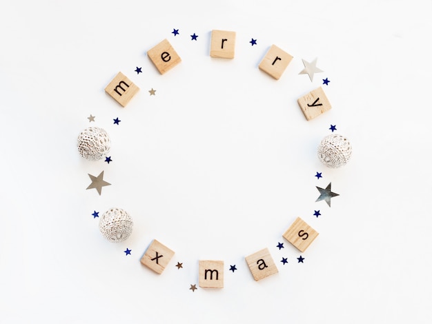 Photo merry christmas decorations, shaped as a circle. silver and blue balls and star confetti.