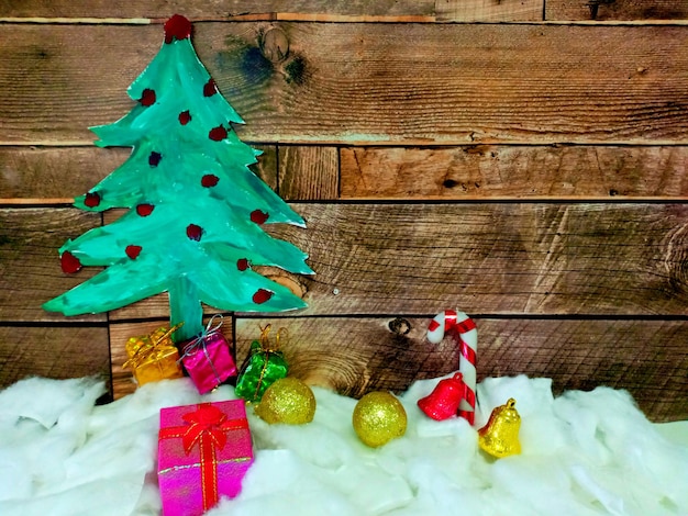 Merry Christmas gift with Christmas tree on wooden background