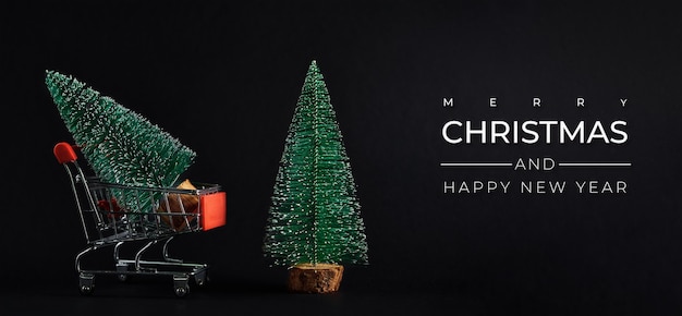 Merry christmas and happy new year composition with christmas tree on dark background