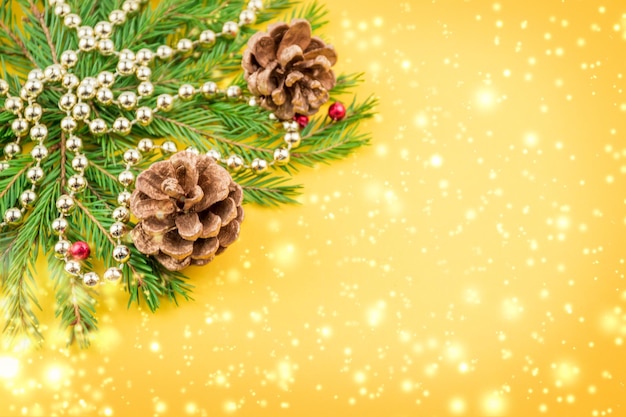 Merry Christmas and Happy New Year green fir branches cones garlands and lights Copyspace