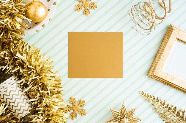 Merry christmas and happy new year greeting card view of gold tinsel, ball, ornament on table