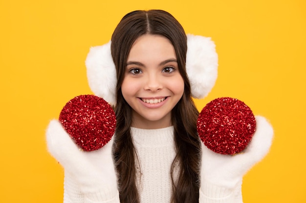 Merry christmas and happy New year Kid in winter clothes Teen girl with decorative christmas ball