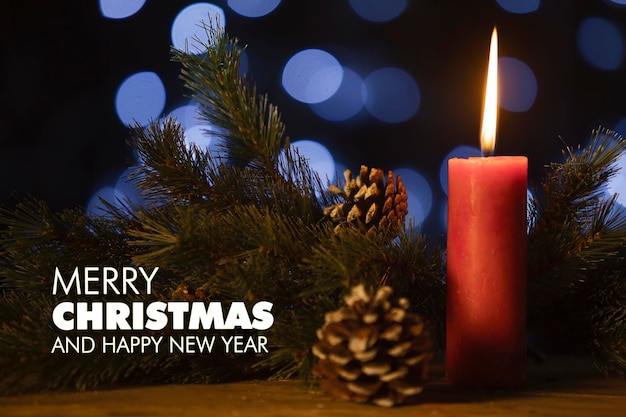 Foto testo di buon natale e felice anno nuovo con la candela