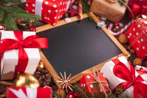 Merry Christmas holiday background - black chalkboard in wooden frame