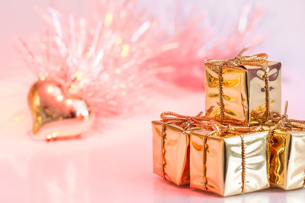 Merry Christmas, New Year, gifts in gold boxes and a golden heart 