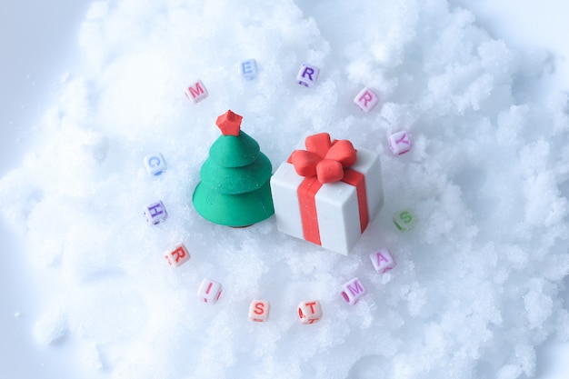 Merry Christmas text with tree and gift toys