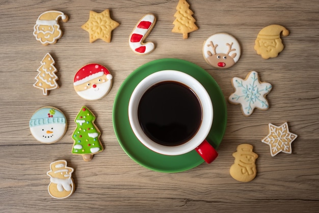 Merry Christmas with homemade cookies and coffee cup on wood table background. Xmas eve, party, holiday and happy New Year concept