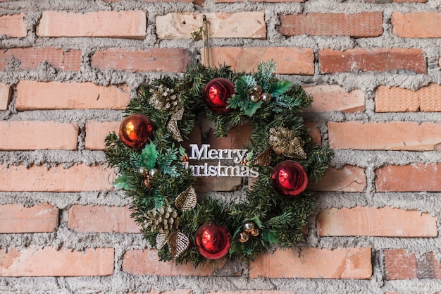 Merry christmas wreath on brick wall