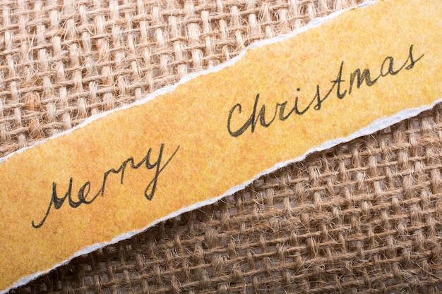 Merry christmas written on a torn paper