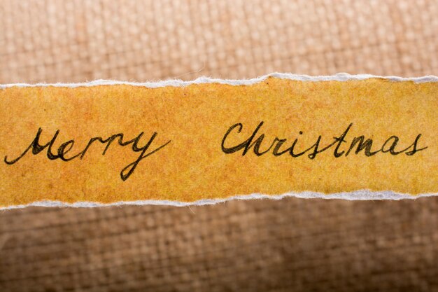 Merry christmas written on a torn paper