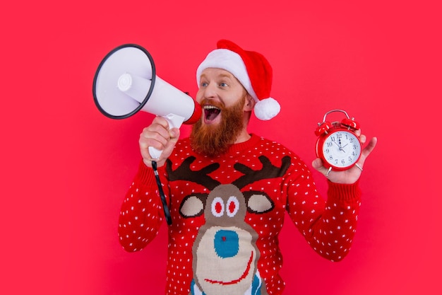 Merry xmas surprised man hold clock announcing in loudspeaker about xmas sales man at xmas