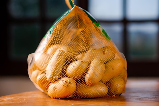 Mesh bag with whole potatoes Sale or purchase of potatoes