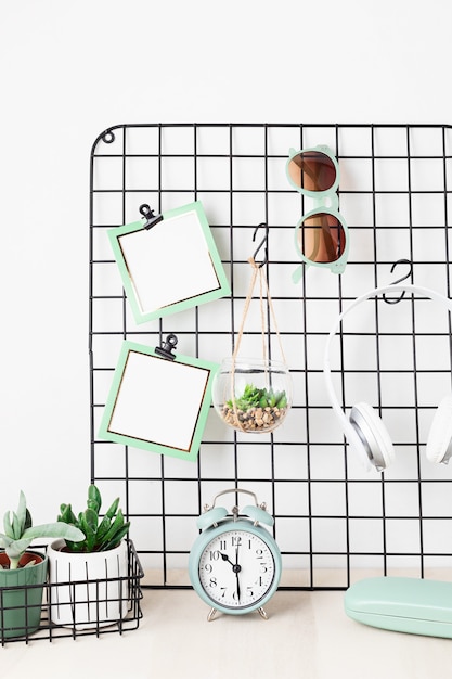 Mesh board with cards, eyeglasses, house plants Stay home, home organisation, decoration, planning, slow living concept