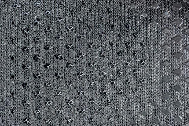 Mesh fabric of sports shoes in gray color Shoes made of mesh fabric with a textile texture for an active lifestyle running and sports Modern running shoes closeup