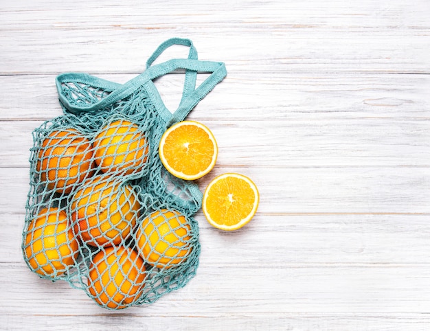 Mesh shopping bag with oranges