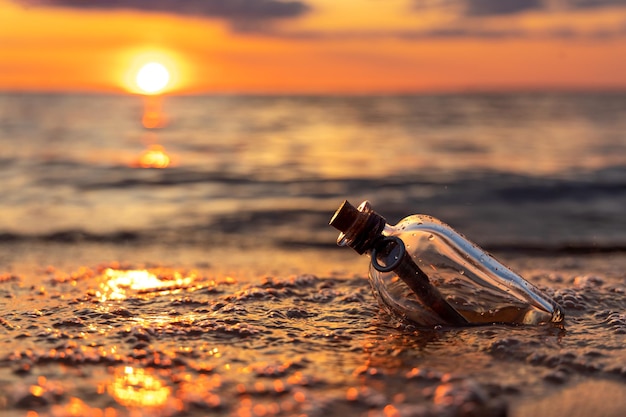 Message in the bottle against the Sun setting down