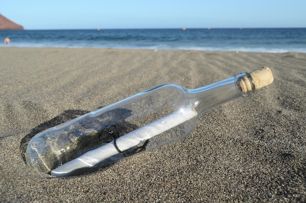 Photo message in a bottle on the sand beach