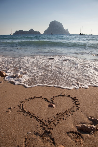 Photo message of love written on the sand on a summer day