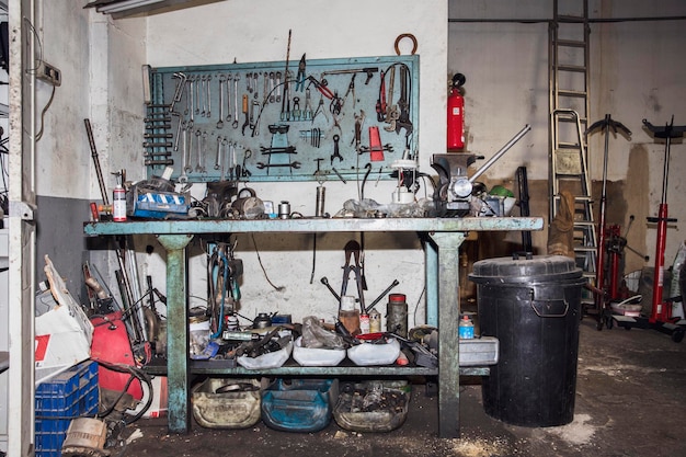 Messy and dirty mechanical workshop bench full of tools