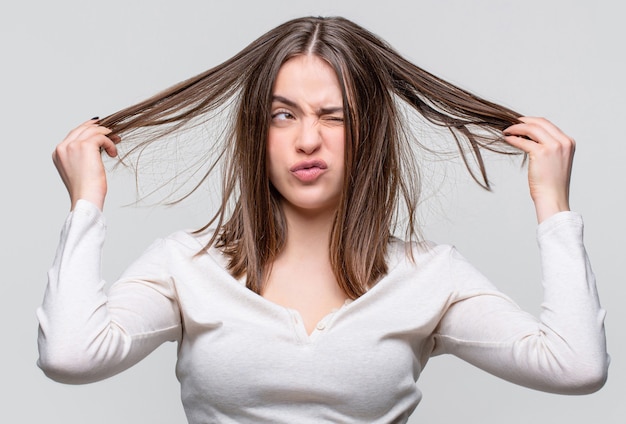 messy hair. brunette woman with messed hairs. girl having a bad hair. bad hairs day