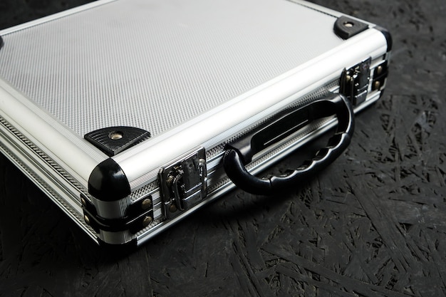 Metal aluminum briefcase on a black background.