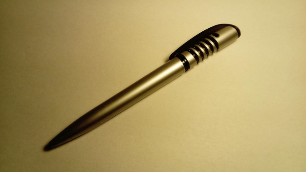 Metal ballpoint pen in soft lighting on a white background