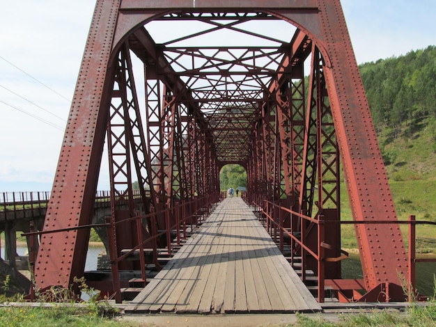 Metal bridge across the lake nature of the Ural mountains