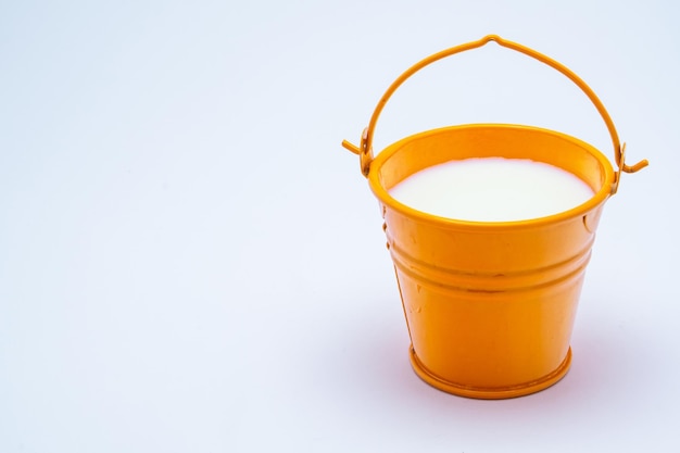 metal bucket with milk isolated on white background