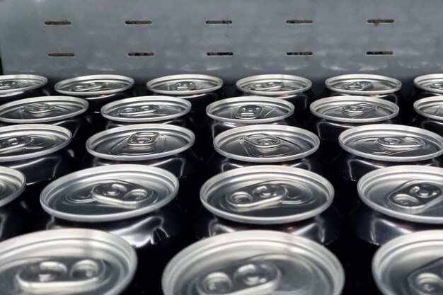 Metal cans with a drink, top view of the lids.