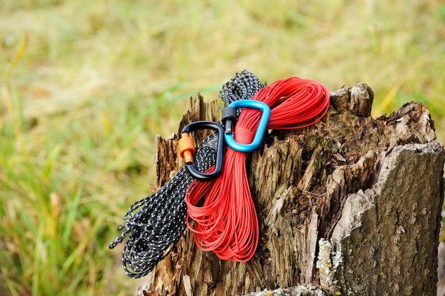 Metal carabine and rope for mountaineering Photo of colored carabines and rope Climbing concept