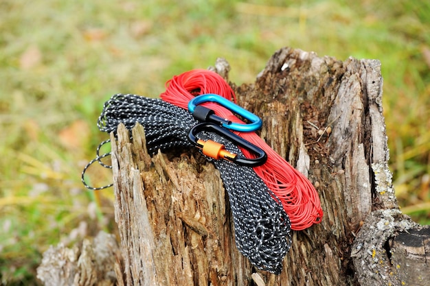 Metal carabine and rope for mountaineering Photo of colored carabines and rope Climbing concept