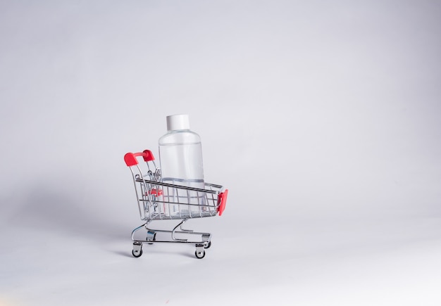 Metal cart with a clear liquid bottle on a white isolated room