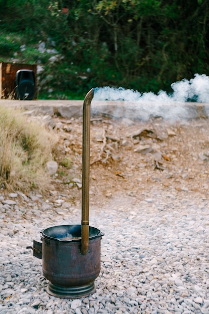 Photo metal cauldron for pilaf with chimney smog