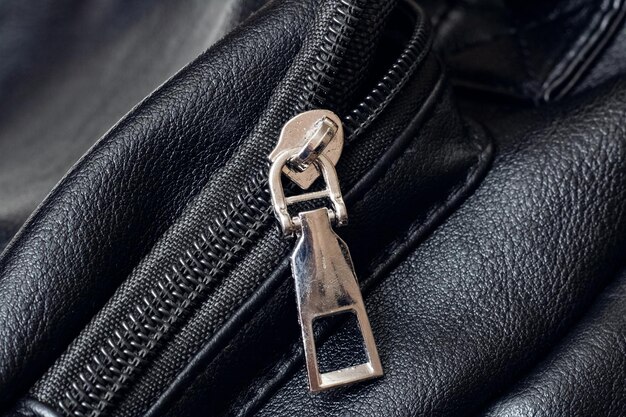 Metal clasp and zipper on leather closeup