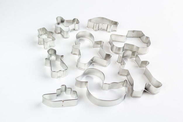 Metal cookie cutters on white surface