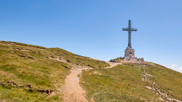 Metal cross on the mountain peak