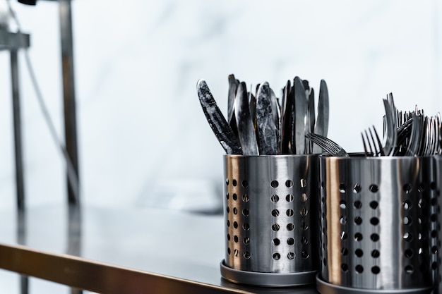 Photo metal cutlery drainers in a professional kitchen in a restaurant close up