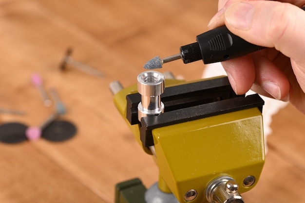 Metal cylinders clamped in a vice