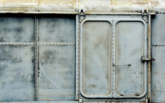 Metal door of old and rusty bogie train